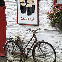 Buy canvas prints of Old Guinness ad and Bicycle, West Cork, Ireland by Phil Crean