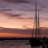 Buy canvas prints of Sunrise over a Sailing Ship by Jim Jones