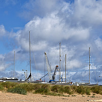 Buy canvas prints of Yachts and Cranes behind the dunes by Jim Jones