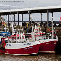 Buy canvas prints of Fishing Boats safely tied up in harbour by Jim Jones