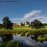 Buy canvas prints of Alnwick Castle reflected in the River Aln. by Jim Jones