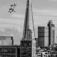 Buy canvas prints of The Shard helicopter fly past by Ian Jones
