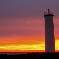 Buy canvas prints of Lighthouse at sunset by Ian Jones