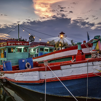 Buy canvas prints of Fishing Boat and Lighthouse by Adrian Evans