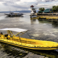 Buy canvas prints of Yellow Tour Boat Nalusuan Island Philippines by Adrian Evans