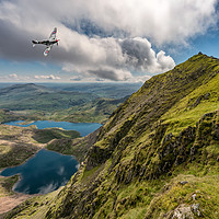 Buy canvas prints of Spitfire over Snowdon by Adrian Evans