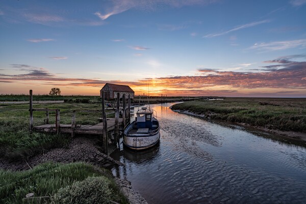 Sunset over the old coal barn in Thornham   Picture Board by Gary Pearson