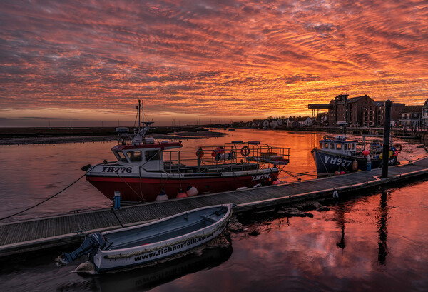 A fiery sky over Wells harbour Picture Board by Gary Pearson