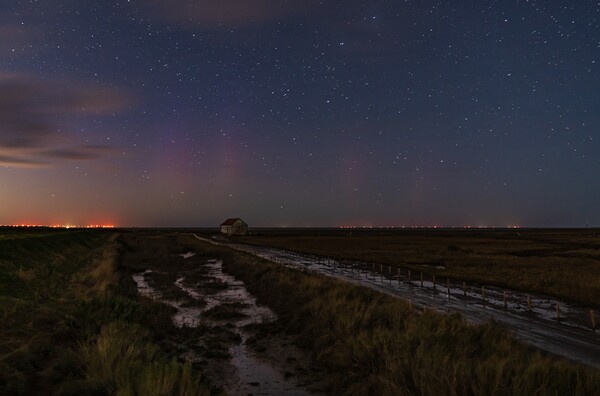 The Northern lights arrive at Thornham in Norfolk  Picture Board by Gary Pearson