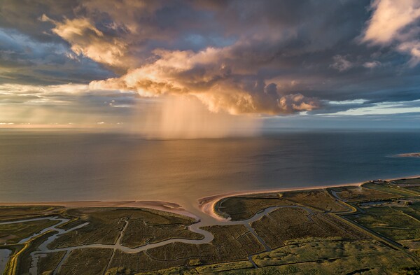 A sunset rain shower out at sea  Picture Board by Gary Pearson