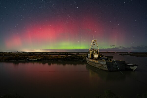 The Northern lights over Brancaster Staithe harbour Picture Board by Gary Pearson