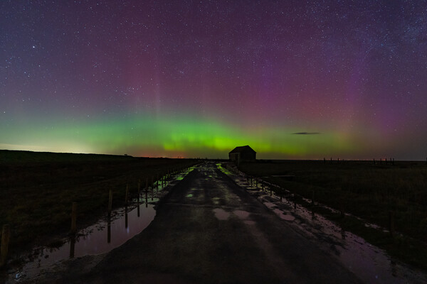 Northern lights dancing over the old coal barn at Thornham  Picture Board by Gary Pearson