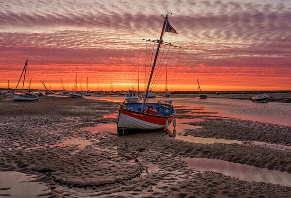 Sunrise over the harbour at Brancaster Staithe  Picture Board by Gary Pearson