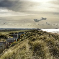 Buy canvas prints of Beach huts in the dunes by Gary Pearson