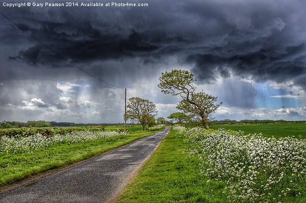 Storm clouds over Ringstead Picture Board by Gary Pearson