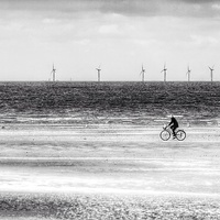 Buy canvas prints of Brancaster beach cyclist by Gary Pearson