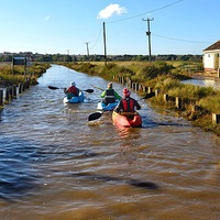 Buy canvas prints of  Kayaking down the road - Brancaster high tide 30/ by Gary Pearson