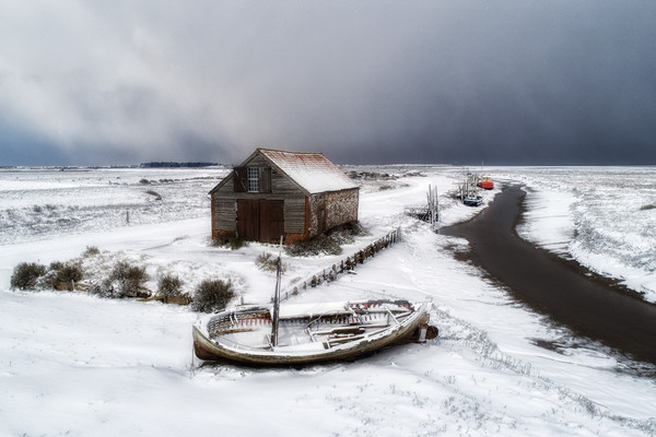 Snow around the old coal barn at Thornham  Picture Board by Gary Pearson