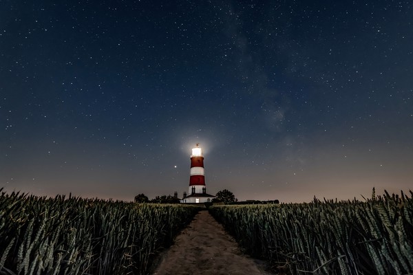 Happisburgh lighthouse under the stars 1 of 2 Picture Board by Gary Pearson