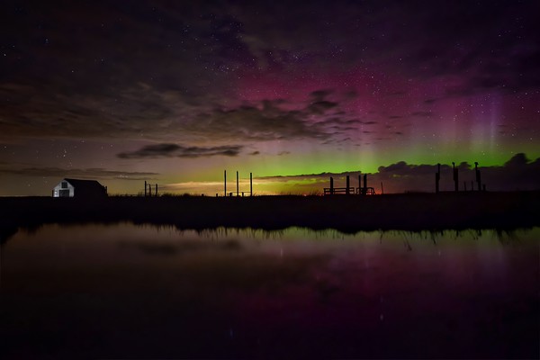 Northern lights over the old coal barn at Thornham Picture Board by Gary Pearson