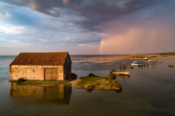 High tide at the old coal barn in Thornham Picture Board by Gary Pearson