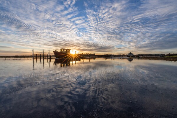 Sunrise reflections at Thornham Picture Board by Gary Pearson