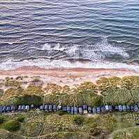 Buy canvas prints of Beach huts nestled in the dunes - Brancaster beach by Gary Pearson