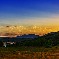 Buy canvas prints of Sun melts behind Pollensa Mountains by Trevor Camp