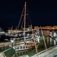 Buy canvas prints of  Tenby harbour night time by Paul Deverson