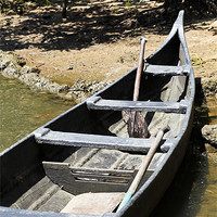 Buy canvas prints of Angled canoe on sandy bank by Arfabita  