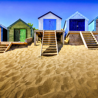 Buy canvas prints of Vibrant Haven: Abersoch Beach Huts by Mike Shields