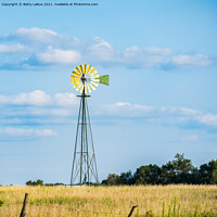 Buy canvas prints of Windmill Against Blue Sky by Betty LaRue