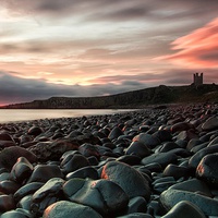 Buy canvas prints of Dunstanburgh castle sunrise by James Marsden