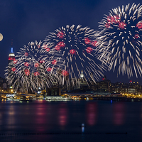 Buy canvas prints of Fireworks and Full Moon Over New York City by Susan Candelario