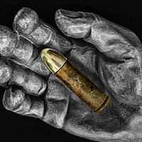 Buy canvas prints of Bullet in hand by Jonathan Thirkell
