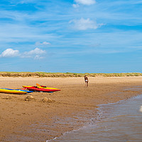 Buy canvas prints of A stroll along the beach past some kayaks, canoes by Jonny Essex
