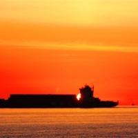 Buy canvas prints of Sunset Silhouette Ship by John Wain