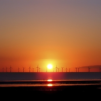 Buy canvas prints of Sunset at the wind farm by John Wain