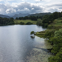 Buy canvas prints of Loughrigg Tarn and the Langdale Pikes by Graham Moore