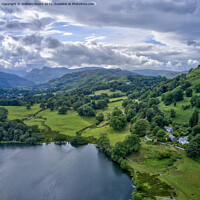 Buy canvas prints of Loughrigg Tarn looking west towards the Langdale Pikes by Graham Moore