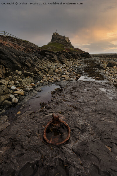 simulated sunrise at lindisfarne castle Picture Board by Graham Moore