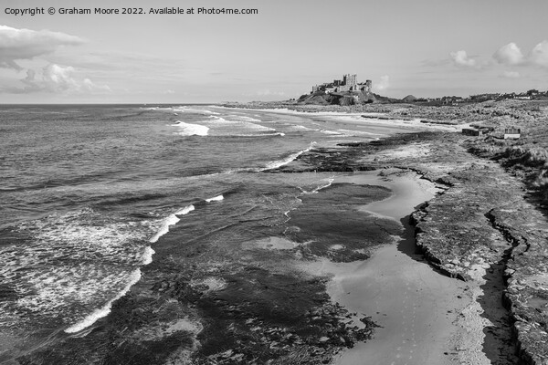 Bamburgh Castle from Harkness Rocks elevated monochrome Picture Board by Graham Moore