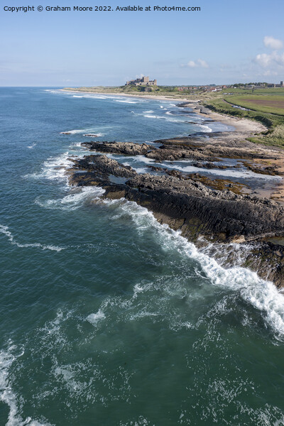 Bamburgh Castle from Harkness Rocks elevated Picture Board by Graham Moore