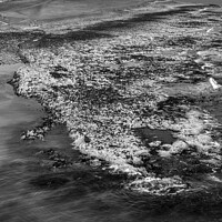 Buy canvas prints of Dunstanburgh Castle from the sea elevated monochrome by Graham Moore