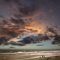 Buy canvas prints of Couple walking on beach at sunset by Graham Moore