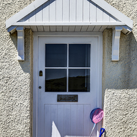 Buy canvas prints of Door with bucket and spade by Graham Moore