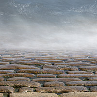 Buy canvas prints of Wave splashes on cobbles by Graham Moore