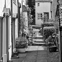 Buy canvas prints of Robin Hoods Bay street monochrome by Graham Moore
