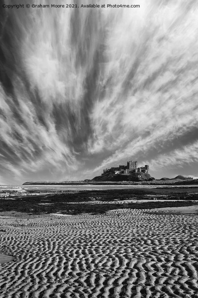 Bamburgh Castle with streaky clouds monochrome Picture Board by Graham Moore