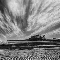 Buy canvas prints of Bamburgh Castle with streaky clouds monochrome by Graham Moore